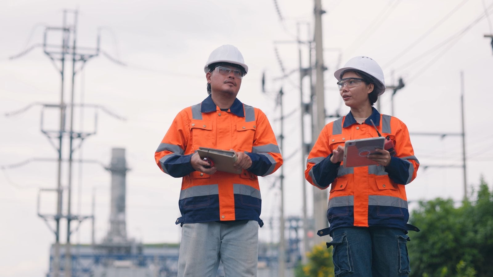 Utility field technicians reviewing work on a tablet