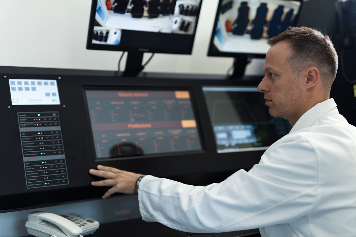 Operator at a modern control room panel