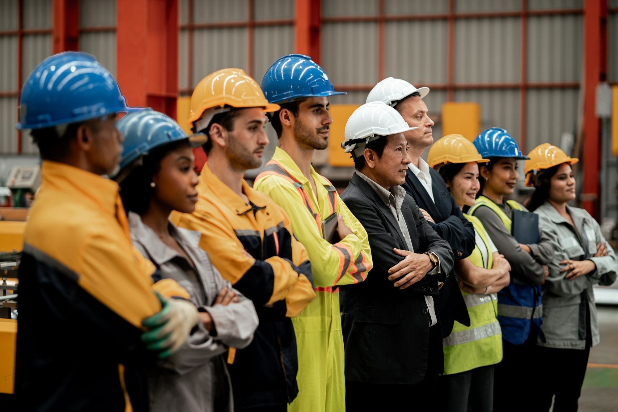 Supervisor briefing a crew beside a forklift in a warehouse