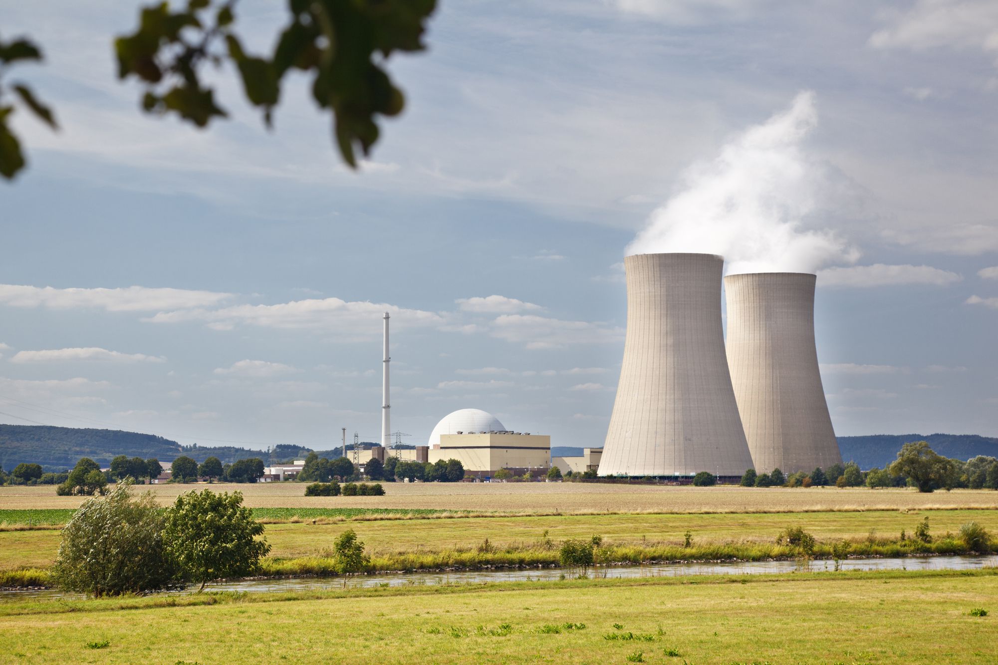 Nuclear generating station with cooling towers in a river landscape